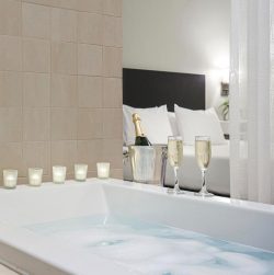 Bathroom with champagne on tub at Casa 425, one of the best places to stay in Claremont